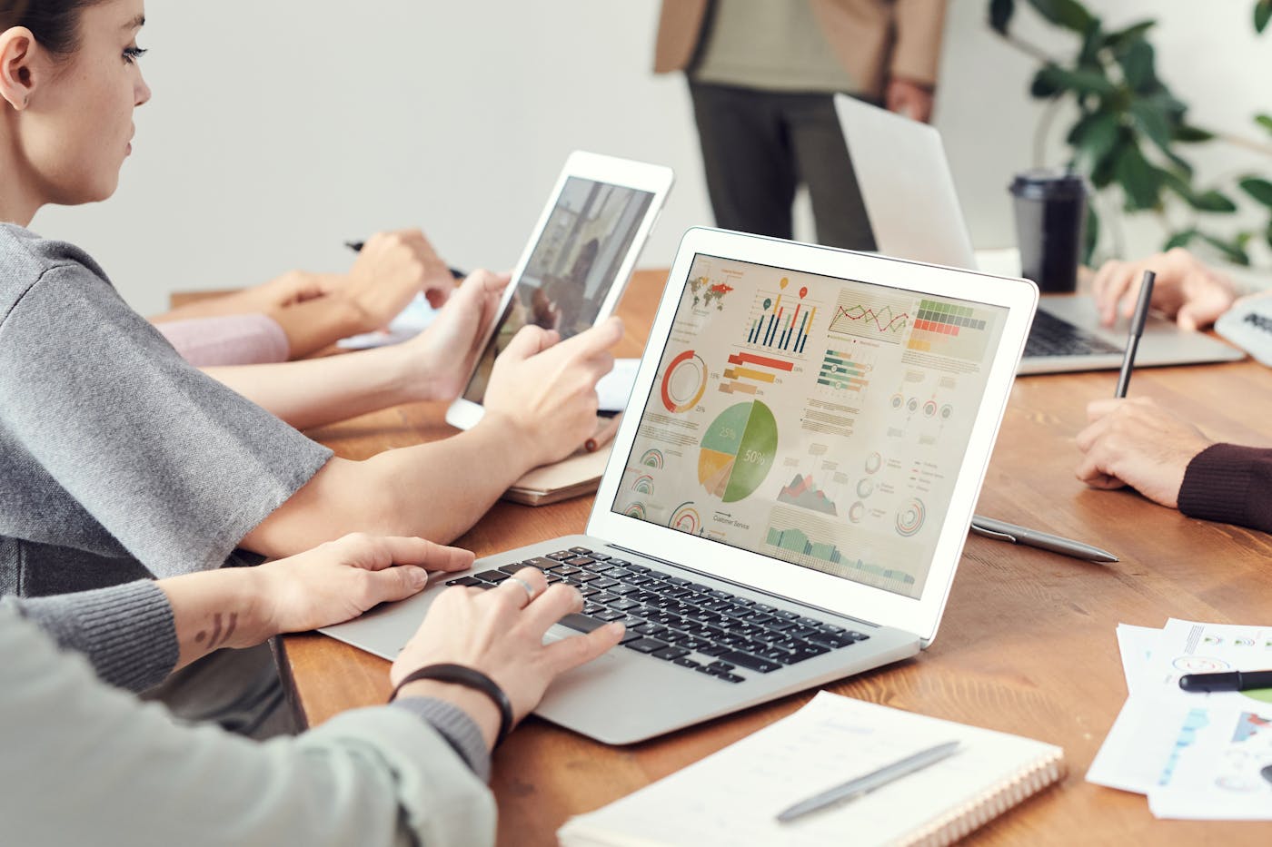 Team reviewing software and reporting dashboards on a laptop